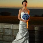 Bride holding flowers at sunset