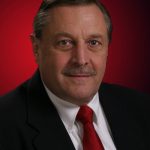 Business portrait of a Mystic Ct man with red background
